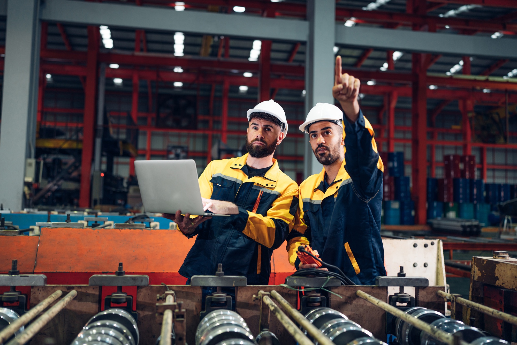 Industrial man engineer checking system machine at factory.